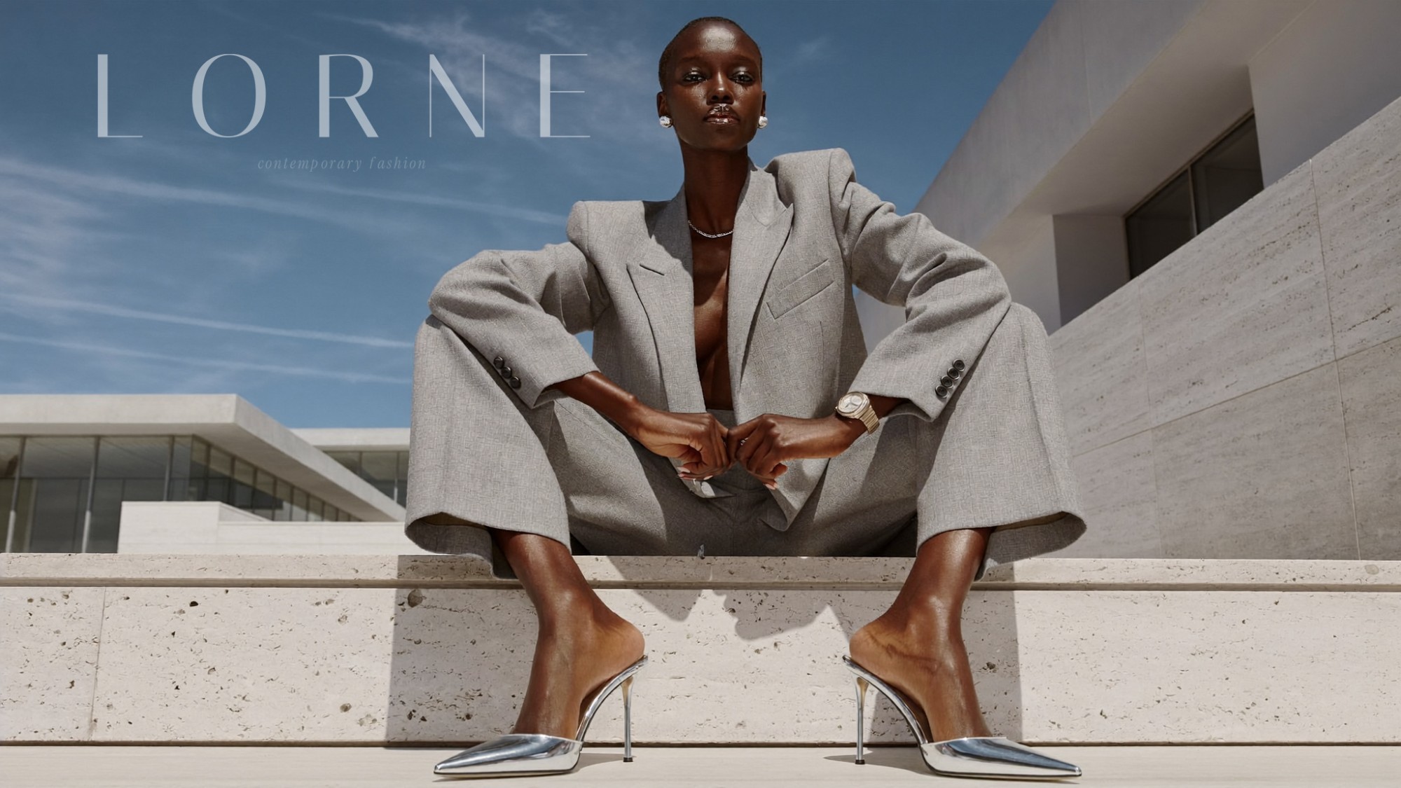 LORNE contemporary fashion campaign — model on travertine steps